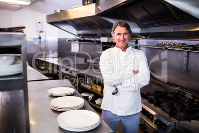 Smiling chef holding ladle in the kitchen