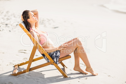 Woman relaxing on an armchair on the beach