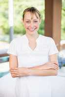Happy female masseur at health spa