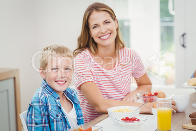 Happy mother and son having breakfast