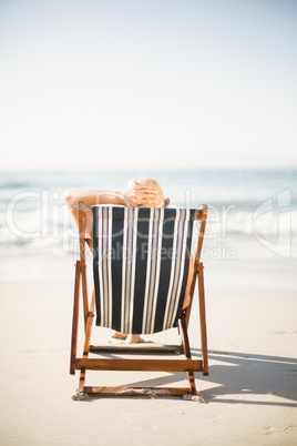 Rear view of woman relaxing on the beach