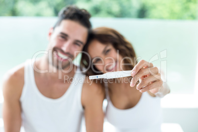 Happy couple showing pregnancy kit