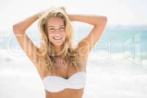 Smiling woman standing at the beach