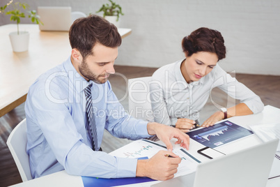 Business people working with documents in office