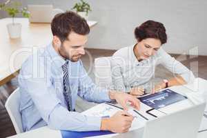 Business people working with documents in office