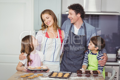 Happy family standing in kitchen