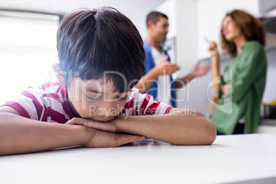 Boy feeling sad while his parents quarrelling