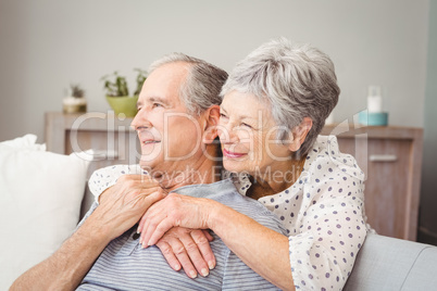 Romantic senior couple sitting in living room