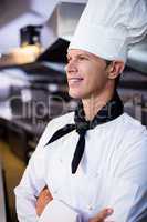 Happy male chef standing with arms crossed