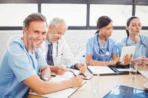 Portrait of male doctor smiling in conference room