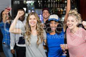 Happy friends watching a match