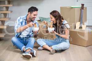 Smiling couple having noodles