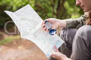 Woman checking map and compass