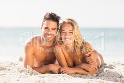 Young couple lying on sand