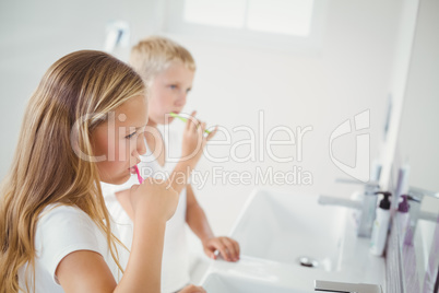 Boy and girl brushing teeth
