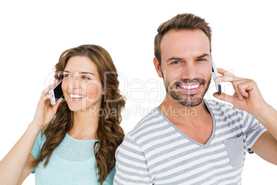 Happy young couple talking on mobile phone