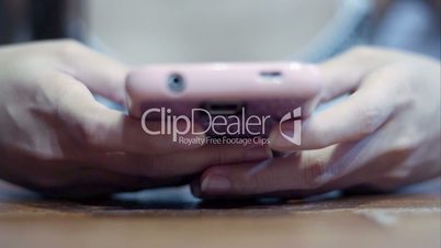 Soft focused girl's hands browsing smartphone