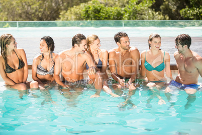 Group of friends having fun in swimming pool