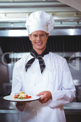 Proud chef holding a plate
