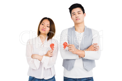 Young couple holding broken heart