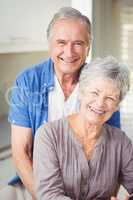 Portrait of happy senior man embracing wife