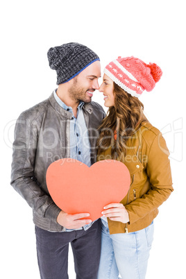 Happy young couple holding heart