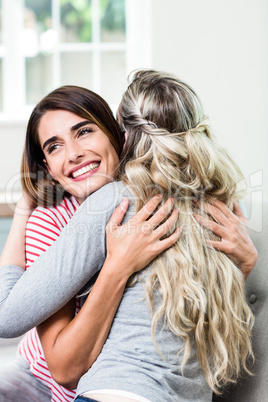 Happy beautiful woman hugging female friend