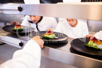 Chef keeping appetizer plate ready on the order station