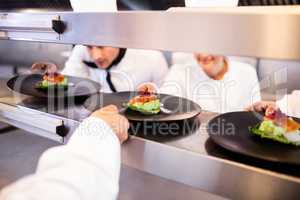 Chef keeping appetizer plate ready on the order station