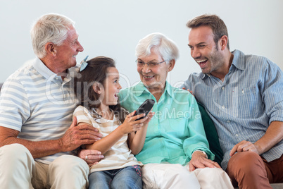 Happy family sitting on sofa