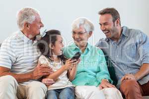 Happy family sitting on sofa