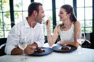 Couple feeding each other and smiling