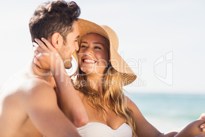 Young couple sitting on sand