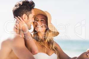 Young couple sitting on sand