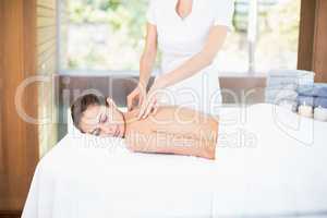 Woman receiving massage from female masseur