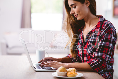 Young woman typing on laptop