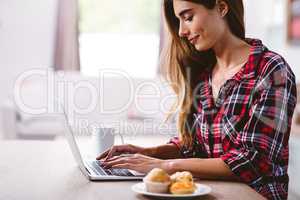 Young woman typing on laptop