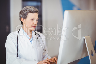 Doctor working at computer desk