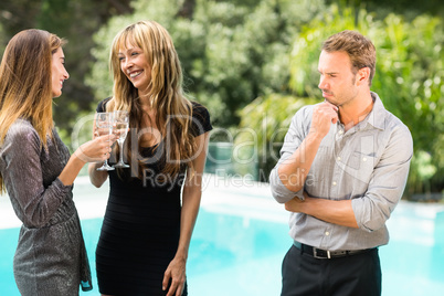 Thoughtful man looking at beautiful women during party