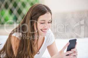 Smiling woman using mobile phone