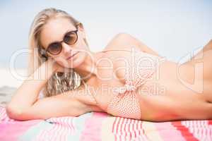 Pretty woman in bikini lying on the beach