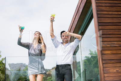 Couple enjoying drinks in balcony