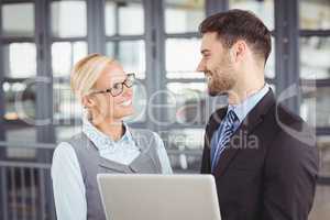 Business people looking face to face in office