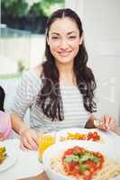 Portrait of smiling woman having food