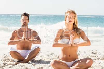 Happy couple doing yoga