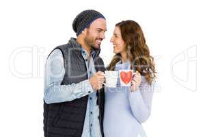Happy young couple holding coffee mug