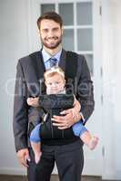 Confident businessman carrying daughter
