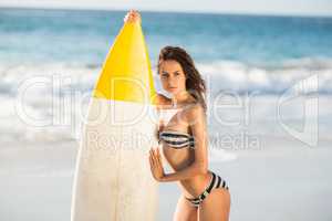 Woman holding surfboard at the beach