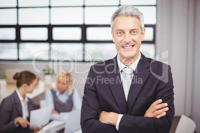 Happy confidence businessman with colleagues in background
