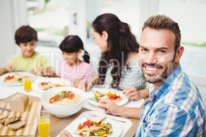 Portrait of smiling father with family